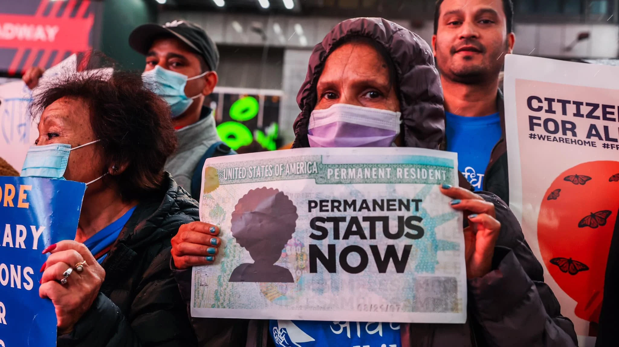 Adhikaar members holding signs at a TPS/Immigration rally at Times Square.